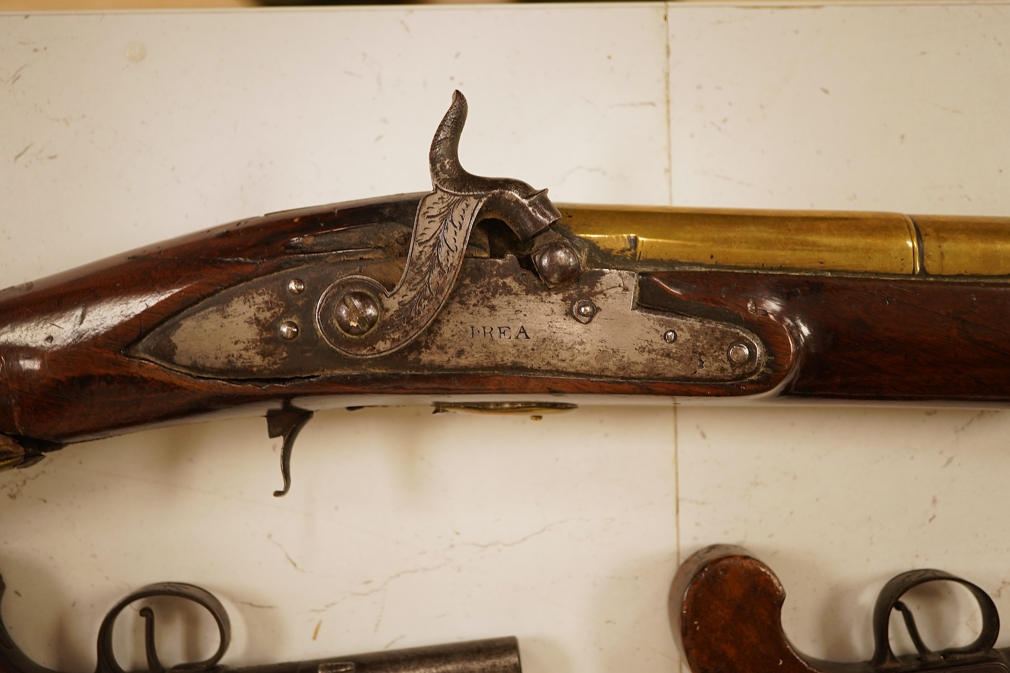 A pair of 19th century pocket pistols, shot flask and a brass musket, 81cm in length